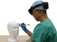 A subject is drawing anatomical structures on the phantom head (His permission for his image to be published was already uploaded.). Source: Image created by the authors; Copyright: The Authors; URL: https://games.jmir.org/2026/1/e75962; License: Creative Commons Attribution (CC-BY).