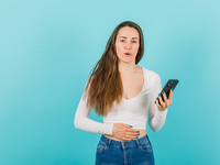 Source: Freepik; Copyright: 8photo; URL: https://www.freepik.com/free-photo/young-girl-with-smartphone-is-holding-hand-stomach-blue-background_26084365.htm; License: Licensed by JMIR.