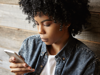 Source: Freepik; Copyright: wayhomestudio; URL: https://www.freepik.com/free-photo/portrait-fashionable-young-dark-skinned-woman-with-afro-hairstyle-having-serious-look_9956758.htm#fromView=search&page=1&position=10&uuid=6cfe5231-a03c-48fd-941e-d4fbeb6ce292&query=black+girl+looking+at+her+phone; License: Licensed by JMIR.