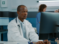 Source: Freepik; Copyright: DC Studio; URL: https://www.freepik.com/free-photo/african-american-doctor-using-computer-plan-appointment-desk-medical-cabinet-health-specialist-with-white-coat-stethoscope-working-consultation-service-give-help-patient_23804009.htm; License: Licensed by JMIR.