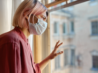 Source: Freepik; Copyright: karlyukav; URL: https://www.freepik.com/free-photo/teenage-girl-with-pinkish-hair-standing-front-closed-window-with-hand-glass-looking-outside-while-staying-home-quarantine-coronavirus-pandemic-social-distancing-concept_11100703.htm; License: Licensed by JMIR.
