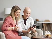 Source: Freepik; Copyright: freepik; URL: https://www.freepik.com/free-photo/middle-aged-woman-with-skin-cancer-spending-time-with-her-friend_14831311.htm#fromView=search&page=1&position=9&uuid=3036df28-10d3-4d64-8d16-2520b2e19498&query=cancer+patient+looking+at+phone; License: Licensed by JMIR.