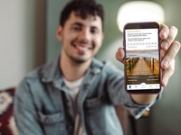 Young man holding mobile device with screenshot of the study app. Source: Authors/iStock; Copyright: Authors/Milko; URL: https://www.jmir.org/2025/1/e83346/; License: Licensed by the authors.